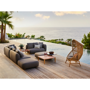 cane-line capture 2-seater sofa right module taupe, cane-line airtouch sofa in a patio with pool and outdoor furniture and hive chair lifestyle