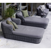lifestyle image of cane-line basket daybed in Graphite, Braid Cane-line Weave w/Grey Cane-line AirTouch in a patio with basket furniture and outdoor cushions