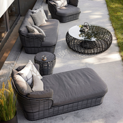 lifestyle image of cane-line basket daybed in Graphite, Braid Cane-line Weave w/Grey Cane-line AirTouch in a patio with basket furniture