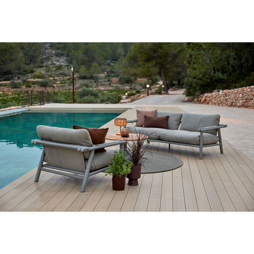 sticks 2 seater sofa Teak sofa desert sand Cane-line Rise cushion in a pool with lounge chair lifestyle