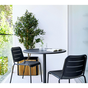 lifestyle image of cane-line combine planter in Square without base type with Teak w/Lava Grey Aluminium color in a balcony with outdoor chairs and table