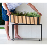 lifestyle image of cane-line combine planter in Rectangular with base type with Teak w/Lava Grey Aluminium color in a patio
