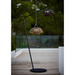 cane-line illusion lamp hanging illusion lamp with stand taupe soft rope without base and dark grey soft rope with lava grey base lit in a patio lifestyle