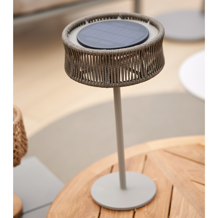 cane-line illusion table lamp medium taupe with taupe round small on a coffee table close up lifestyle