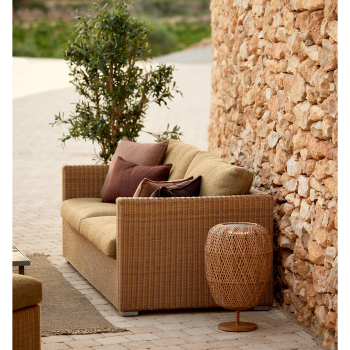 cane-line illusion glow table lamp medium natural with teak in a patio with sofa lifestyle