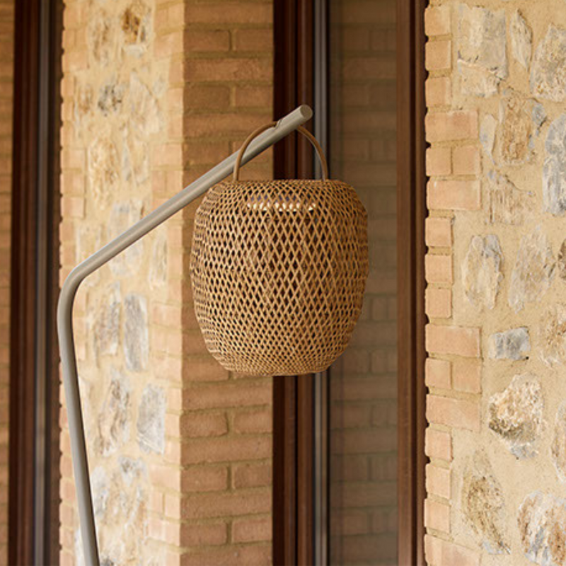 cane-line illusion glow lamp hanging natural with taupe base in a patio lifestyle