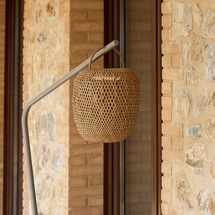 cane-line illusion glow lamp hanging natural with taupe base in a patio lifestyle