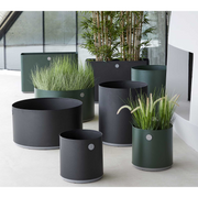 lifestyle image of all sizes in a patio with plants