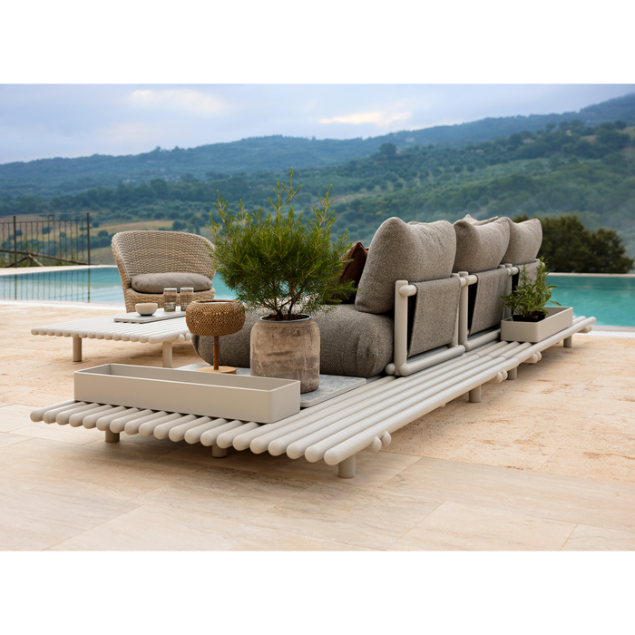 cane-line club storage box sand,aluminium storage box in a patio with sticks platform sofa lifestyle