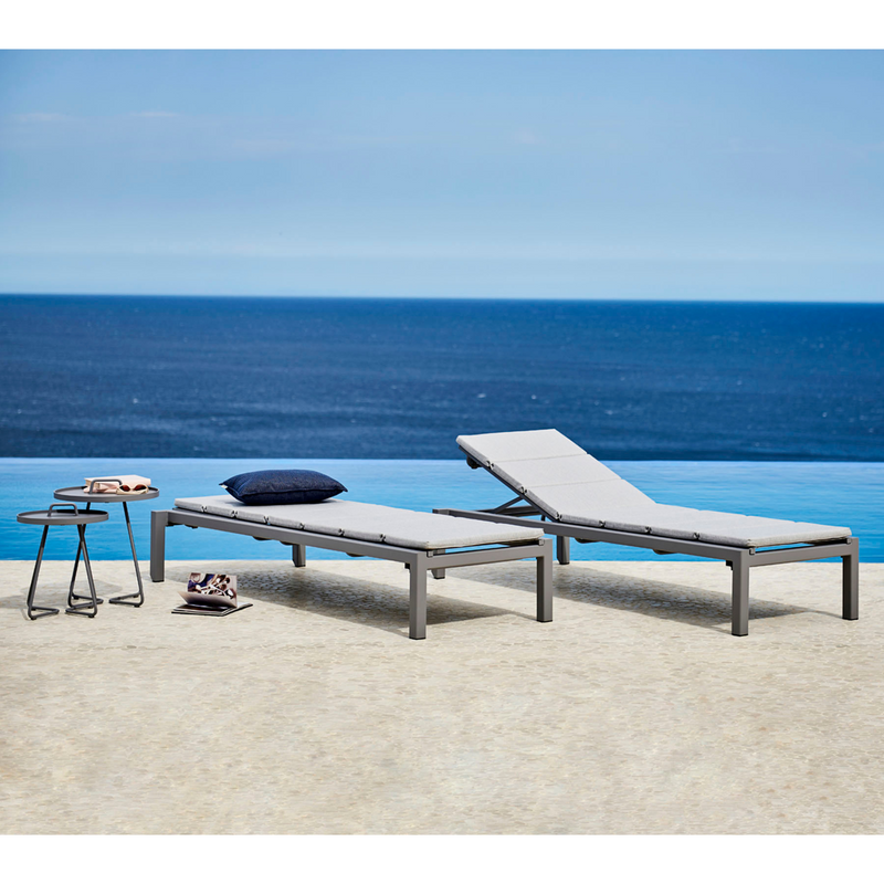 cane-line relax sunbed Light grey, Cane-line Tex with Light grey, Cane-line Natté cushion in a patio with outdoor furniture lifestyle
