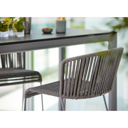 lifestyle image of cane-line moments bar chair in Grey, String Open Cane-line Soft Rope in a lounge close up