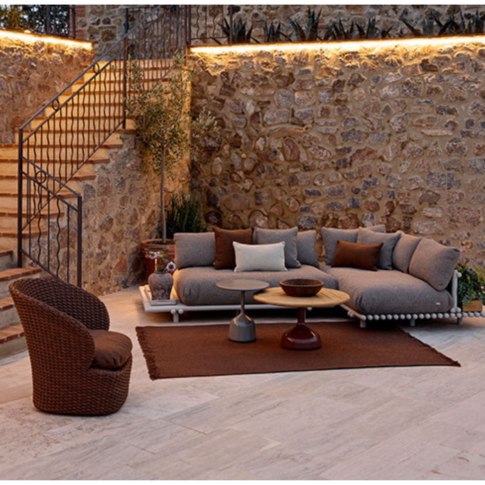 cane-line knit rug 94 x 66 umber brown soft rope in a patio with outdoor furniture lifestyle