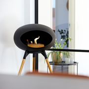 Le Feu Black Dome Bioethanol Fireplace ground high black bowl, rose gold legs and rose gold burner indoor lifestyle