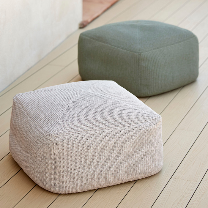 lifestyle image of cane-line divine footstool in Desert Sand, Cane-line Rise and cane-line divine footstool in Dusty Green, Cane-line Divine in a patio