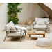 lifestyle image of cane-line divine footstool in Desert Sand, Cane-line Rise in a patio with sticks outdoor furniture