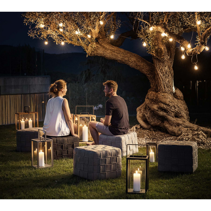 lifestyle image of all colors in a garden with two people enjoying the footstool