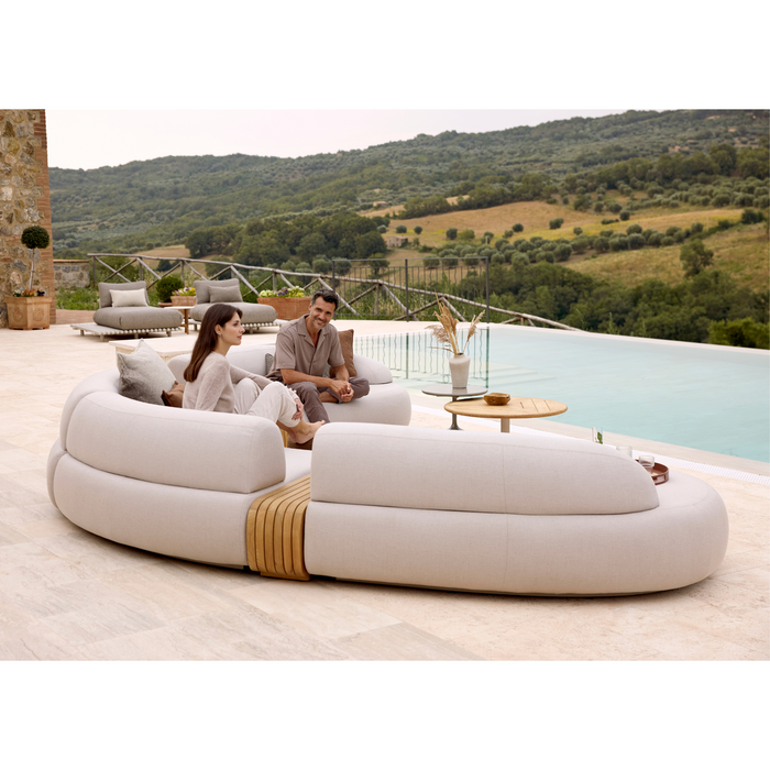 cane-line mellow 6 seater sofa Sand, Cane-line AirTouch sofa in a patio with outdoor furniture and two people enjoying the sofa lifestyle