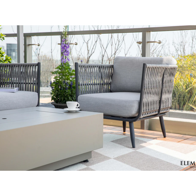 Elementi Milano Dark Grey Powder-Coated Frame w/ Granite Cushions Rope Weaving Armchair with a cofee table on a balcony.