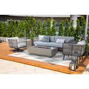 Outdoor patio Elementi Milano Dark Grey Powder-Coated Frame w/ Granite Cushions Rope Weaving set with a fire pit table on a wooden deck.