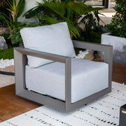 Elementi Newporrt collection Urbane Bronze Powder-Coated Frame w/ Granite Cushions outdoor modern chair on a patio with plants in the background