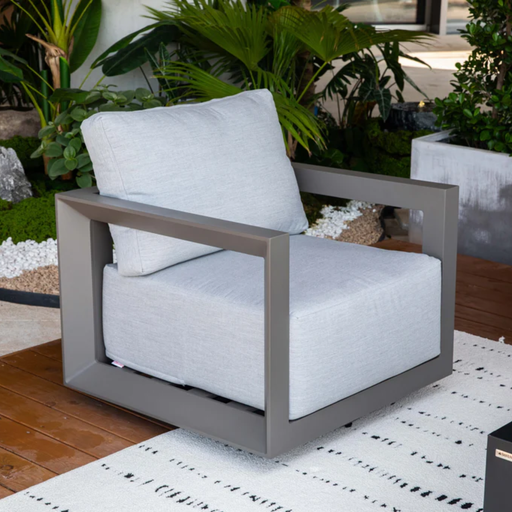 Elementi Newporrt collection Urbane Bronze Powder-Coated Frame w/ Granite Cushions outdoor modern chair on a patio with plants in the background