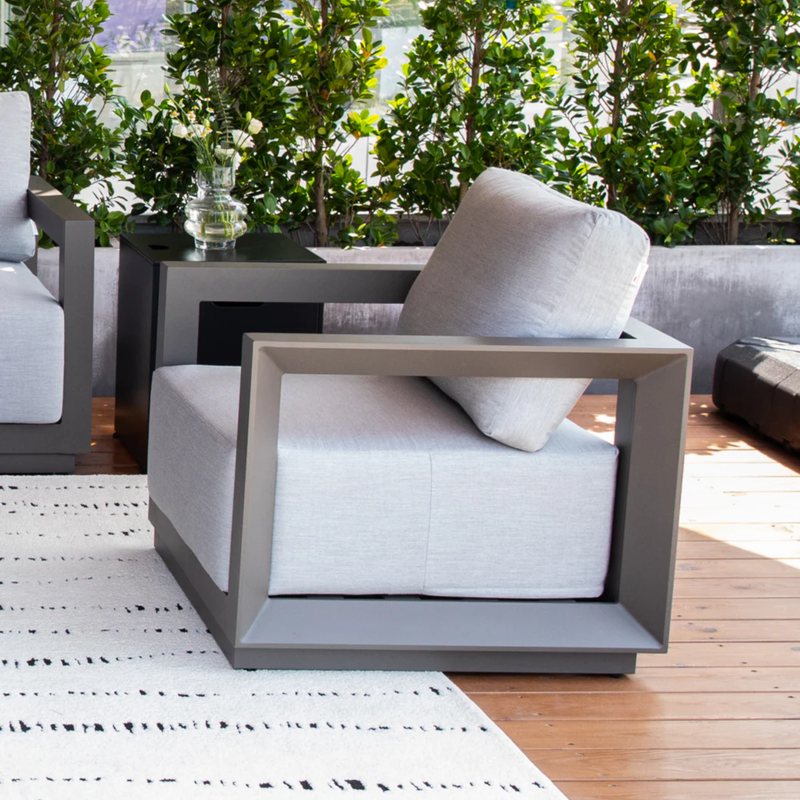 Elementi Newporrt collection Urbane Bronze Powder-Coated Frame w/ Granite Cushions outdoor Modern Chair on a wooden deck.