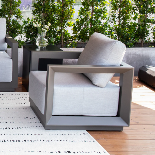 Elementi Newporrt collection Urbane Bronze Powder-Coated Frame w/ Granite Cushions outdoor Modern Chair on a wooden deck.