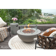 Modeno Roca Fire Table in a patio with ind screen and outdoor furniture lifestyle