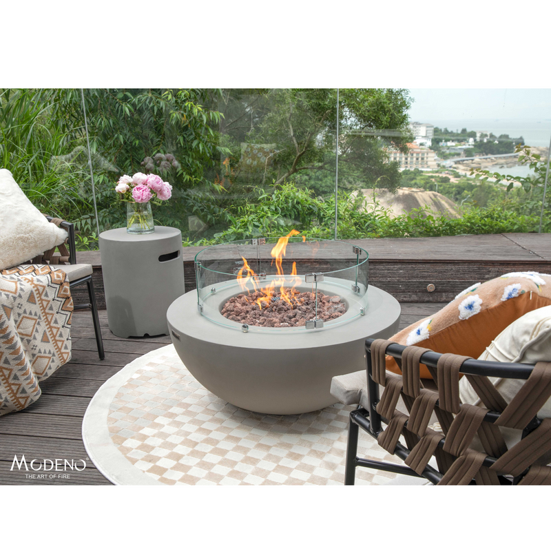 Modeno Roca Fire Table in a patio with ind screen and outdoor furniture lifestyle