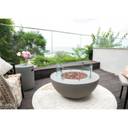 Modeno Roca Fire Table in a patio with wind screen and outdoor furniture lifestyle