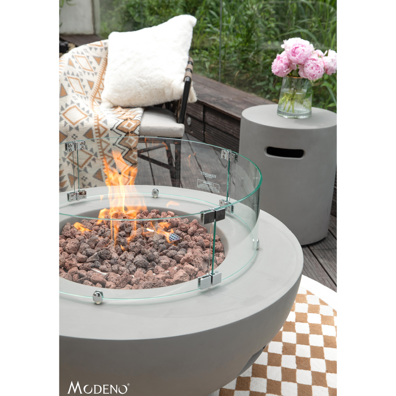 Modeno Roca Fire Table in a patio with wind screen and tank cover lifestyle