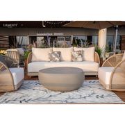 3 seater sofa and 2 swivel chairs with Taupe Powder-Coated Frame w/ Cream Cushions
Weaving Style Round Rope and coffee table on a rug with in a deck patio 'Elementi' branding in the background.