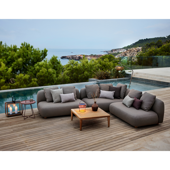 cane-line capture coffee table teak without table top in a patio with pool and outdoor furniture lifestyle