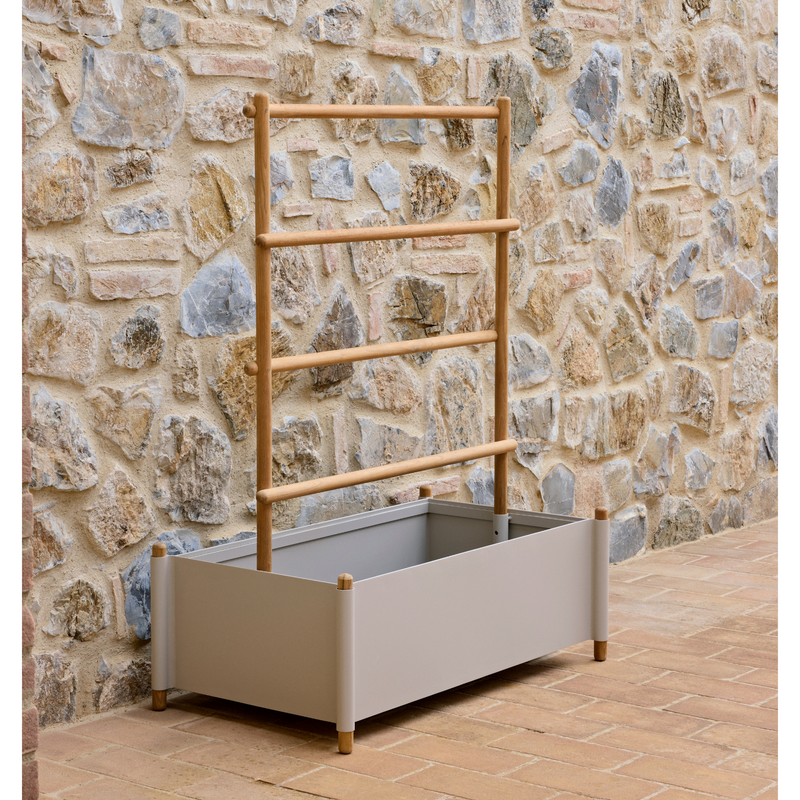 lifestyle image of cane-line sticks planter rack with planter in Teak w/Sand Aluminium in a patio