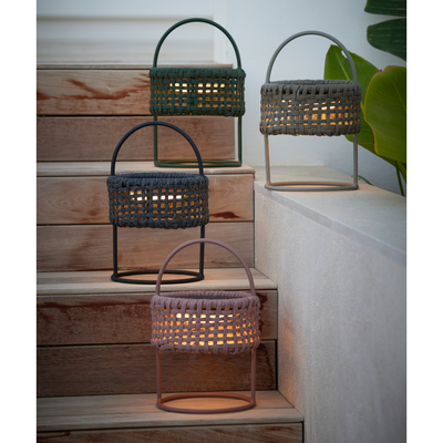 cane-line illusion lamp solar led with dark grey soft rope, solar led with dark green soft rope, solar led with dark rose soft rope and solar led with taupe soft rope lit in a patio lifestyle