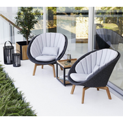 Cane line Peacock lounge chair Dark grey, medium flat Cane-line Soft Rope w/teak and Light grey, Cane-line Natté cushion in a patio lifestyle
