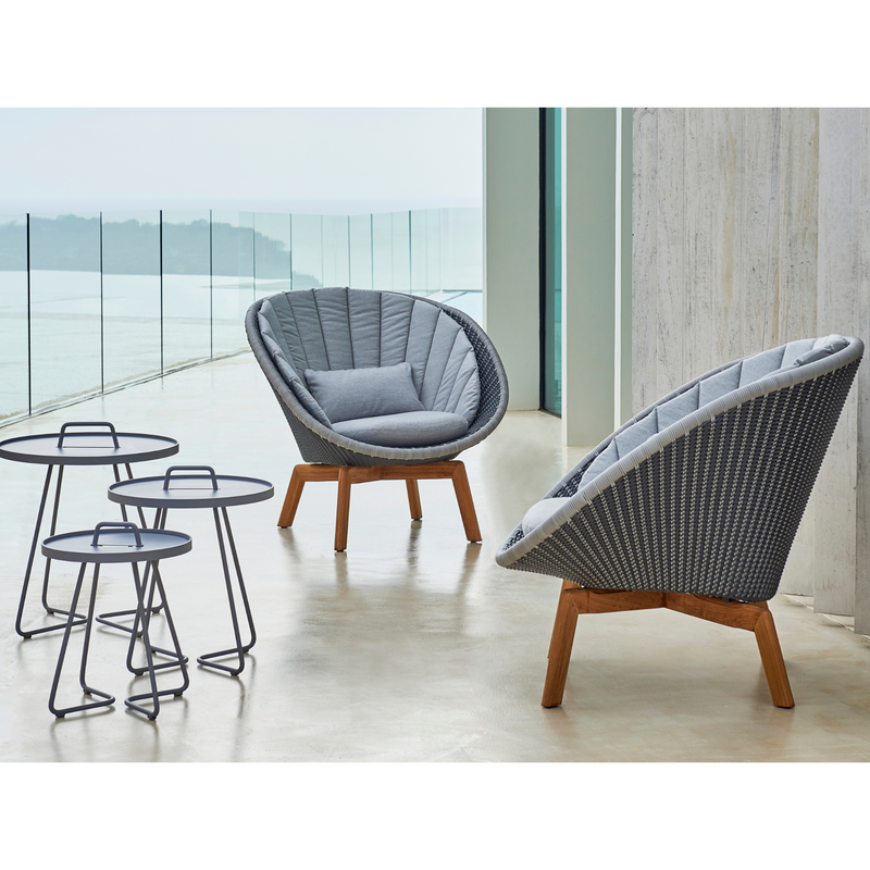 Cane line Peacock lounge chair Grey/light grey, small flat Cane-line Weave w/teak and Light grey, Cane-line Natté cushion in a patio lifestyle