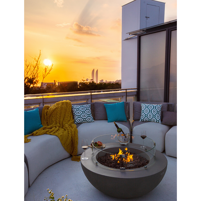 Elementi  Lunar Fire Pit lifestyle picture on a rooftop sun set. 