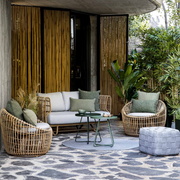 Cane line Nest outdoor round chair Natural Light Grey Natte cushion in a patio with outdoor furniture lifestyle