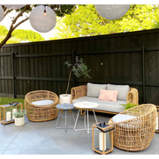 Nest outdoor 2 seater Sofa Light Grey Natte cushion in a patio with outdoor furniture lifestyle