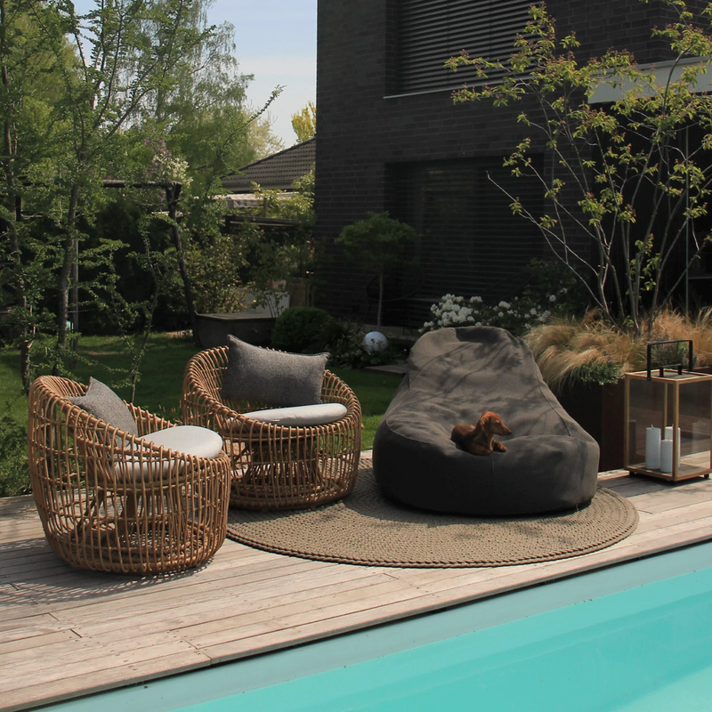 Cane line Nest outdoor round chair Natural Light Grey Natte cushion in a pool with outdoor furniture lifestyle