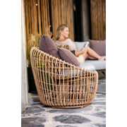 Cane line Nest outdoor round chair Natural Light Grey Natte cushion in a patio lifestyle