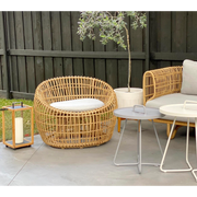 Cane line Nest outdoor round chair Natural Light Grey Natte cushion in a patio with outdoor furniture lifestyle