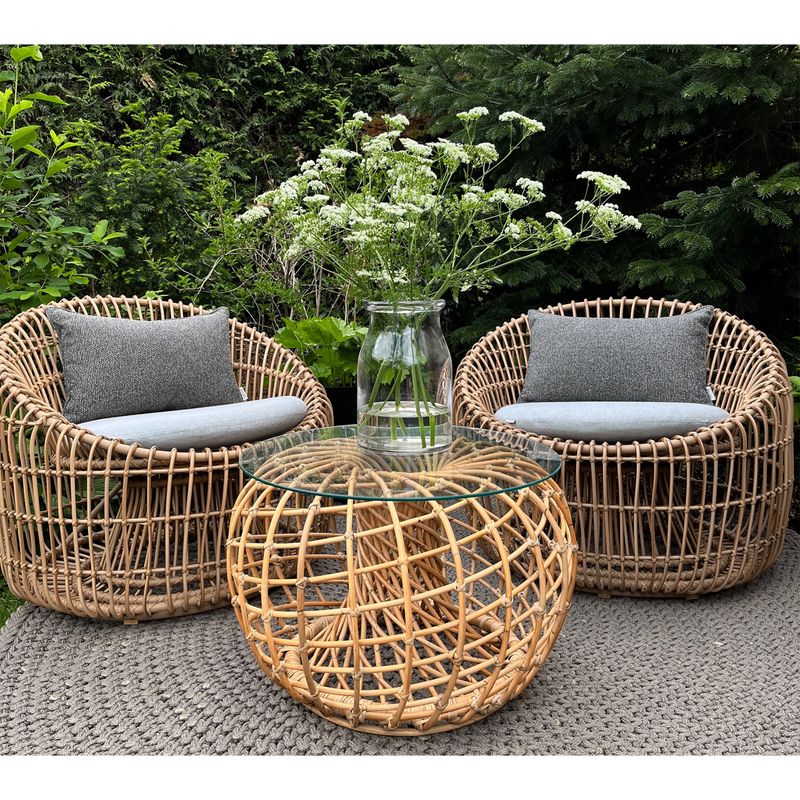 Cane line Nest outdoor round chair Natural Light Grey Natte cushion in a garden nest coffee table lifestyle