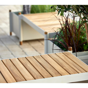 cane-line Sticks bench incl. 2 planters teak sand aluminium in a patio lifestyle